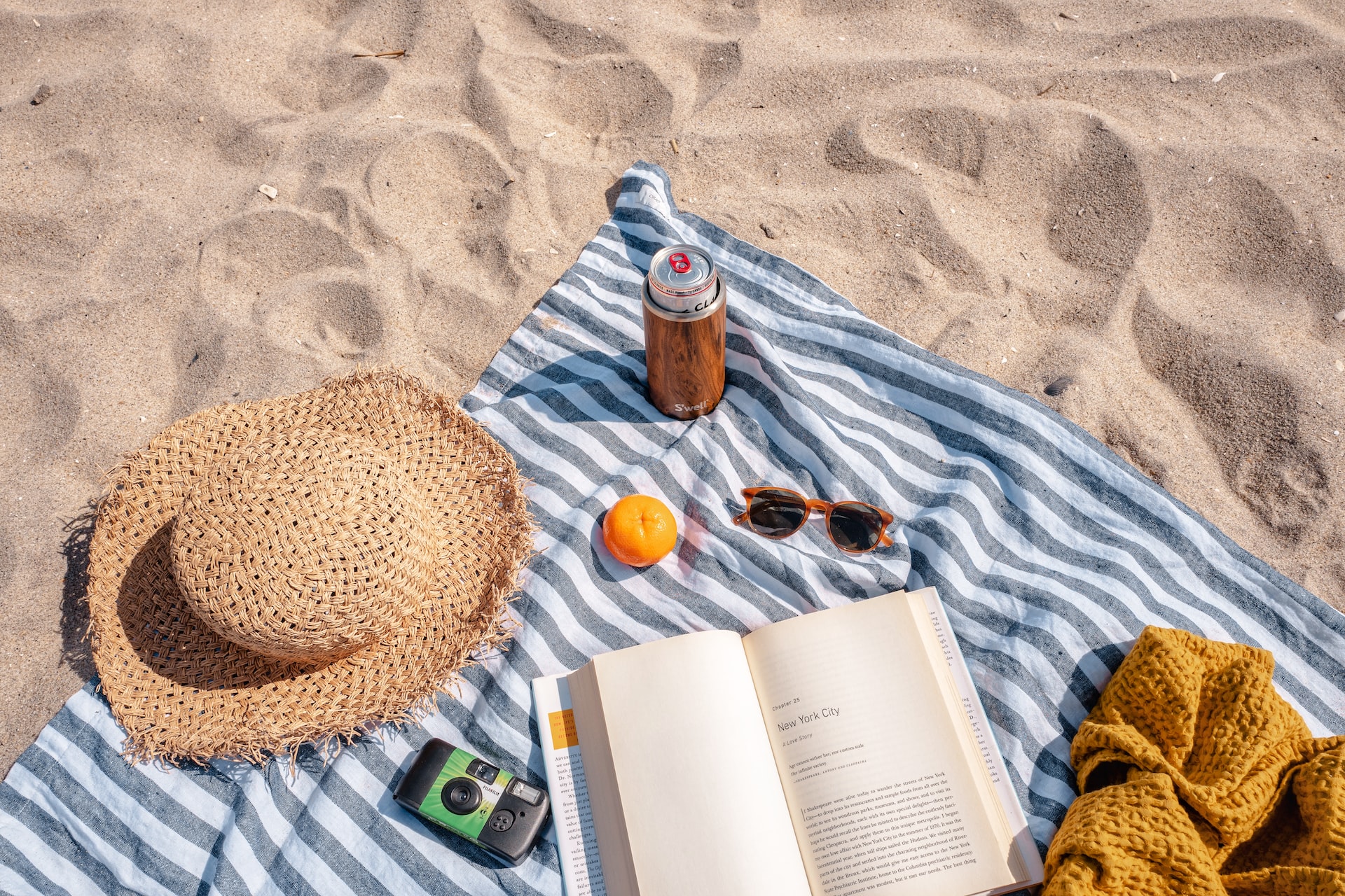 Brown Glass Bottle Beside White Book...