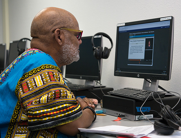an adult student studying at a computer