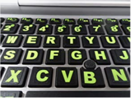 A picture of a keyboard with large yellow keyboard stickers for easy reading.
