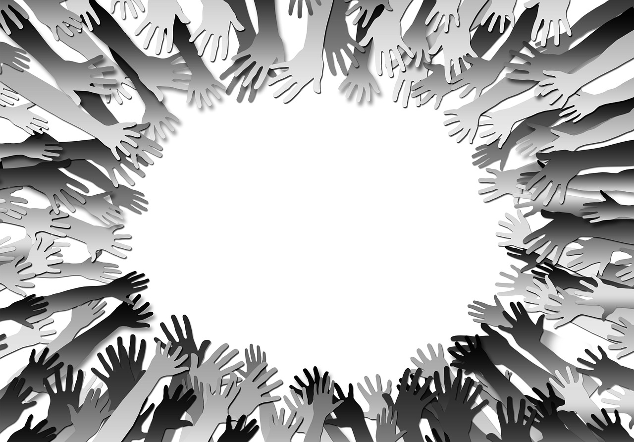 Black and white illustration of hands reaching toward a center point