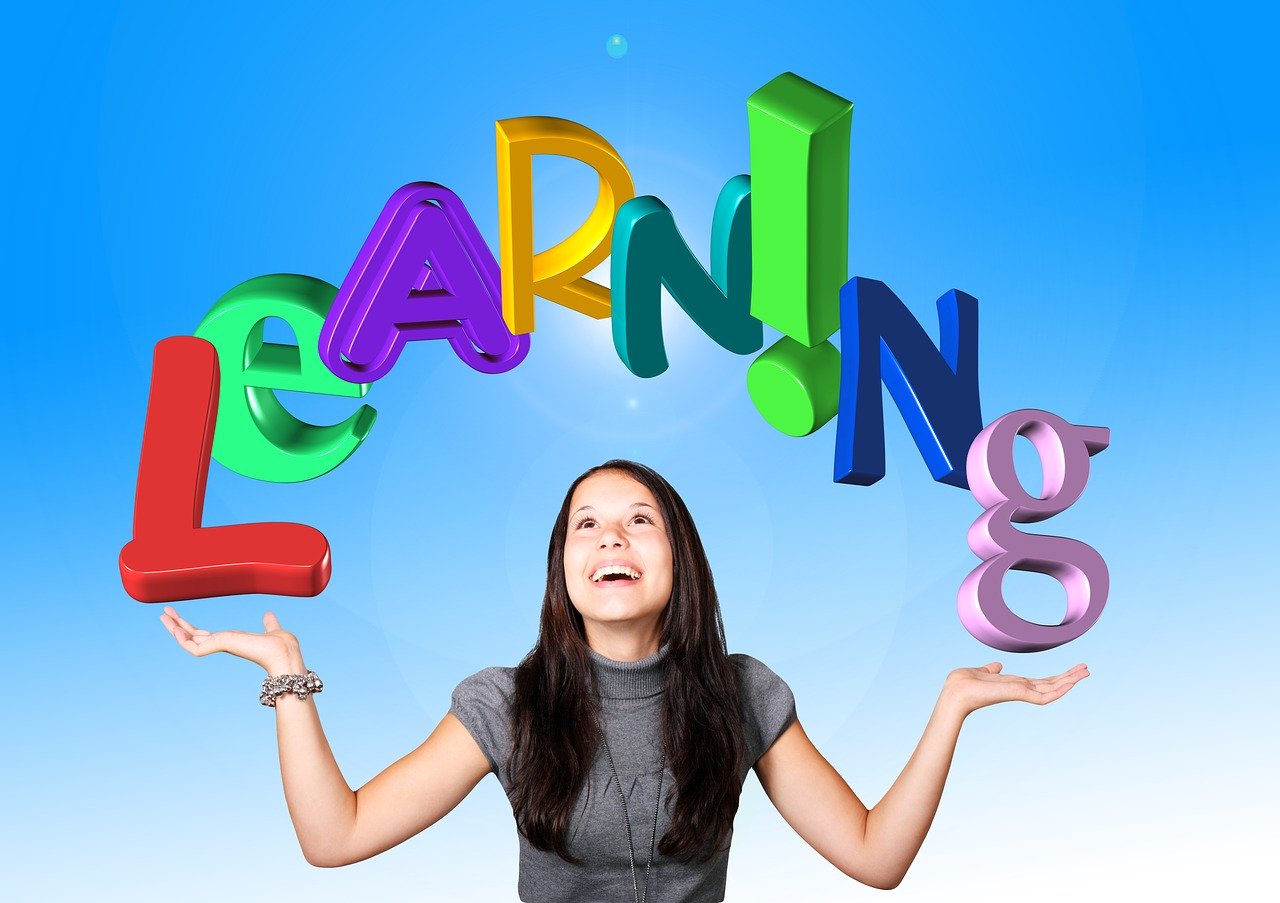 Girl with arms open and the word 'Learning' over her head.